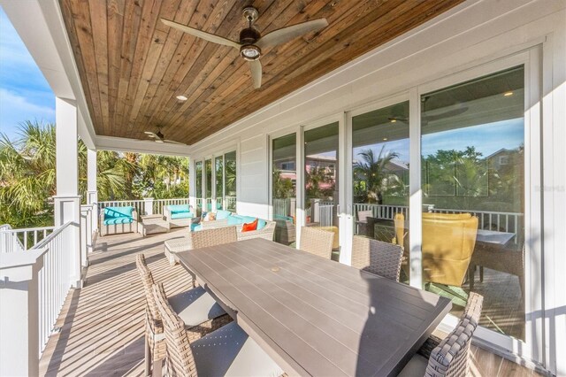 wooden deck with ceiling fan, an outdoor living space, and a pool