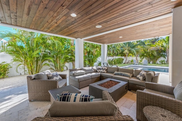 view of patio with an outdoor living space with a fire pit and a fenced in pool