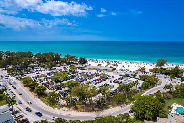 drone / aerial view with a beach view and a water view