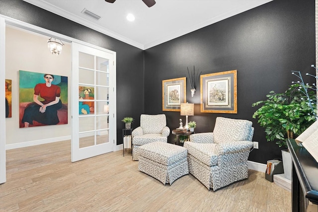 sitting room featuring ceiling fan, crown molding, and light hardwood / wood-style flooring