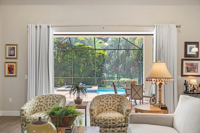 living area with a wealth of natural light and hardwood / wood-style floors