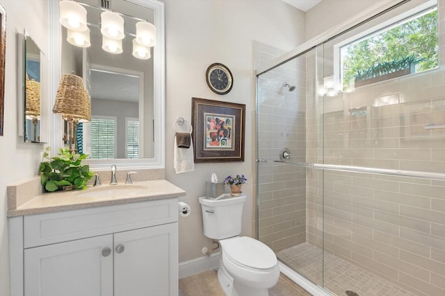 bathroom with tile patterned flooring, toilet, a shower with door, and vanity