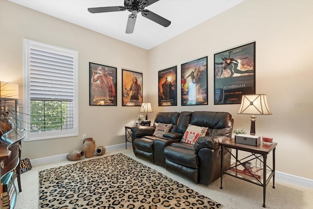 carpeted living room with ceiling fan