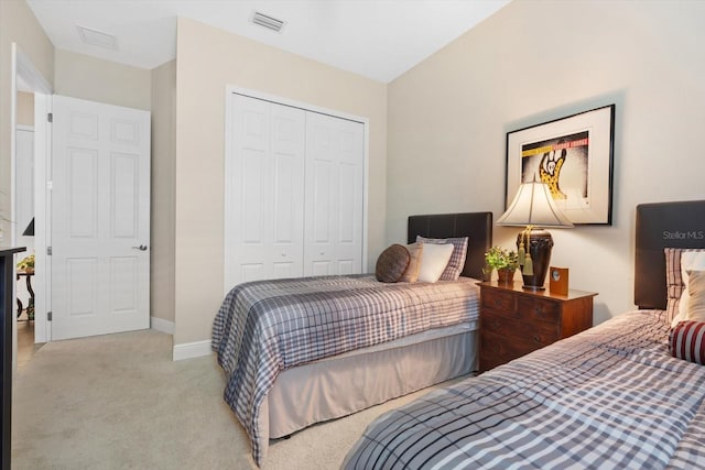 bedroom with light colored carpet and a closet