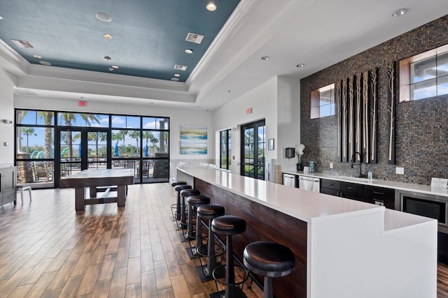 kitchen with french doors, dark hardwood / wood-style flooring, a healthy amount of sunlight, and a kitchen island