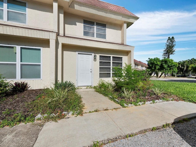 entrance to property featuring stucco siding