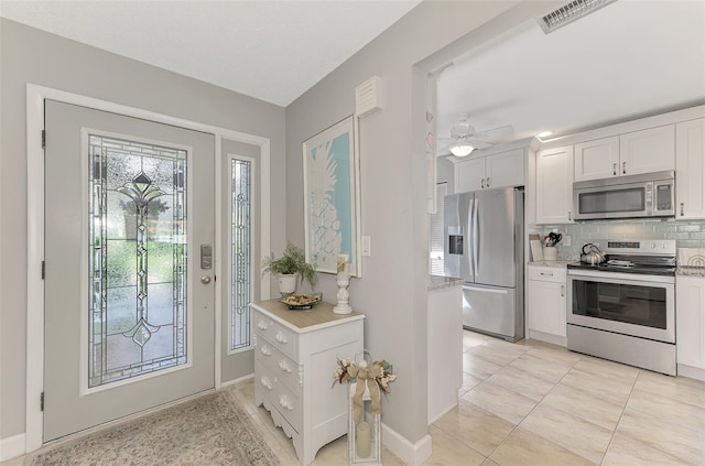 interior space featuring ceiling fan and light tile patterned floors