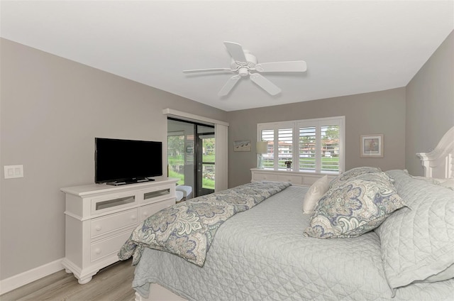 bedroom featuring access to exterior, ceiling fan, and light hardwood / wood-style floors