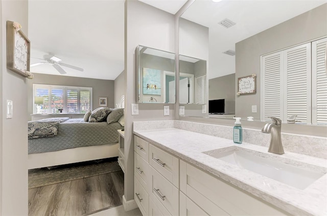 bathroom with vanity, ceiling fan, and hardwood / wood-style flooring