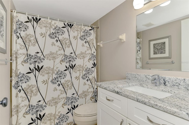 bathroom with vanity, toilet, and a shower with shower curtain