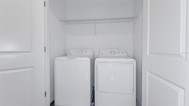 clothes washing area featuring independent washer and dryer