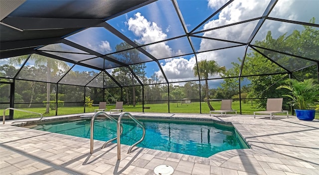 pool with a lawn, a lanai, and a patio area