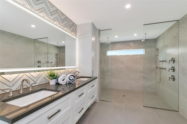 full bathroom with double vanity, recessed lighting, a walk in shower, and a sink