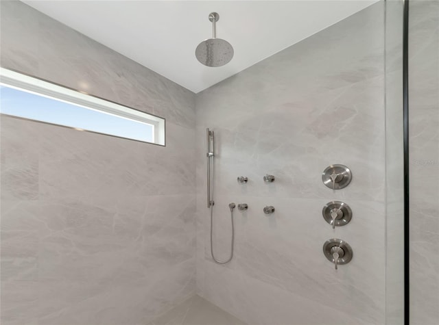 bathroom featuring a tile shower