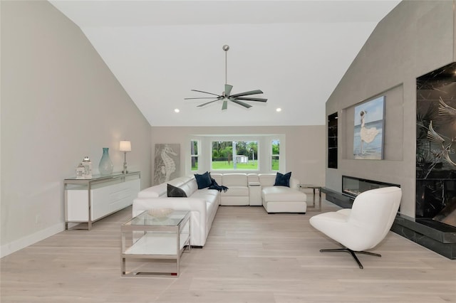 living room with light wood finished floors, recessed lighting, a large fireplace, and baseboards