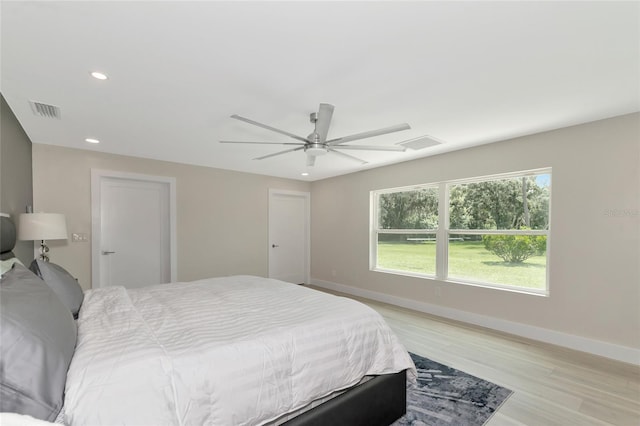 bedroom featuring visible vents, recessed lighting, light wood-type flooring, and baseboards