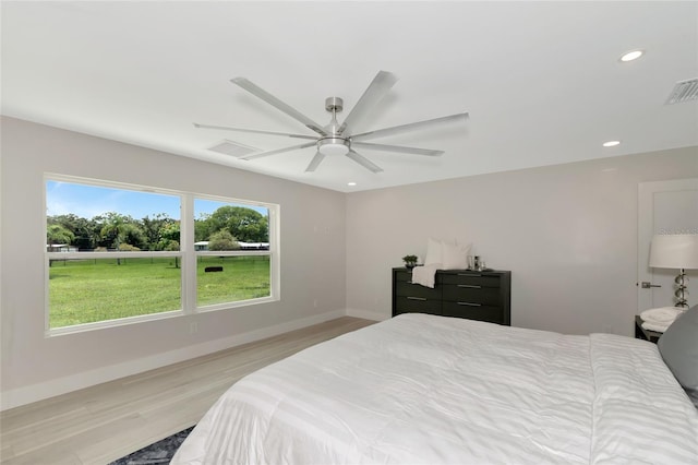 bedroom with visible vents, recessed lighting, light wood-style floors, and baseboards