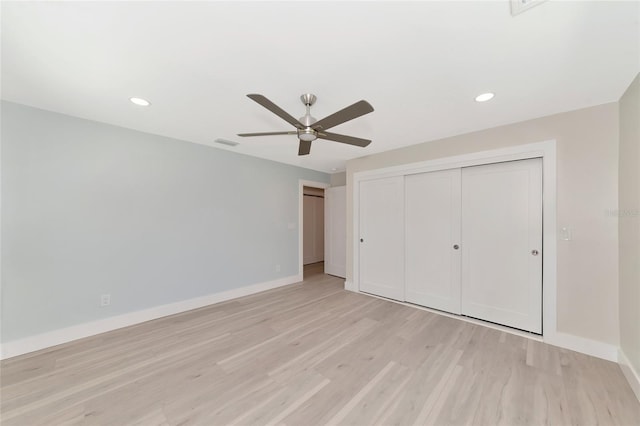 unfurnished bedroom featuring a closet, visible vents, light wood-type flooring, and baseboards