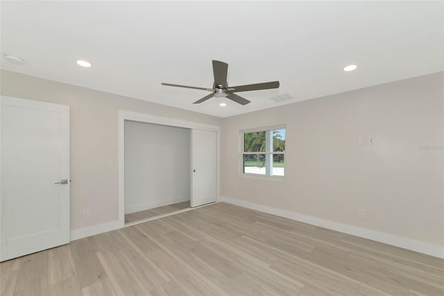 unfurnished bedroom featuring recessed lighting, baseboards, light wood-type flooring, and a closet