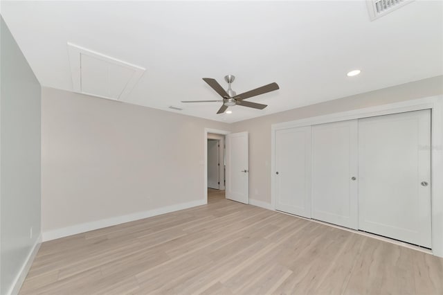 unfurnished bedroom with baseboards, attic access, recessed lighting, a closet, and light wood-type flooring