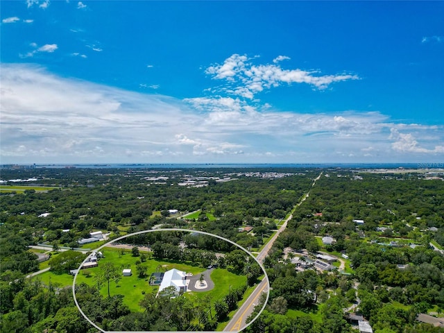 birds eye view of property featuring a wooded view