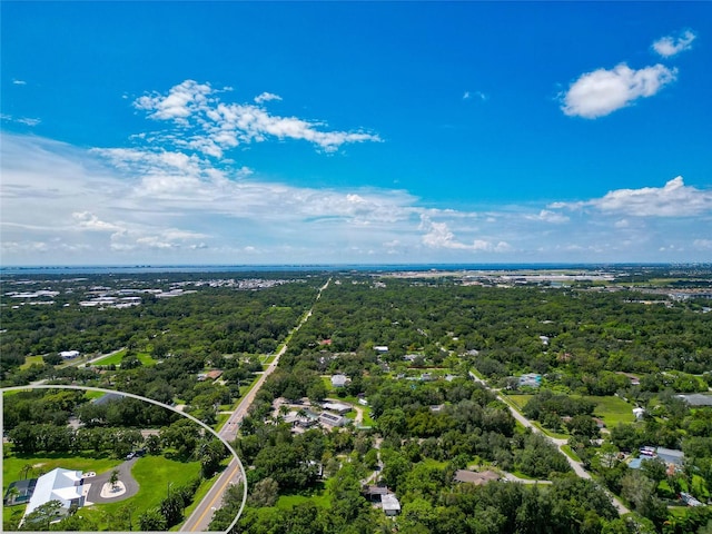 birds eye view of property featuring a view of trees