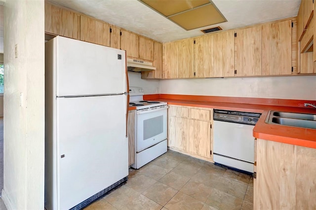 kitchen featuring white appliances, sink, and light brown cabinetry