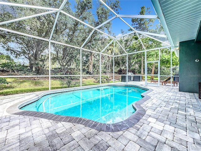 outdoor pool with a patio and a lanai