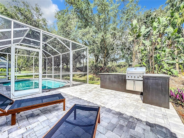 view of patio / terrace with an outdoor pool, area for grilling, a lanai, and a grill