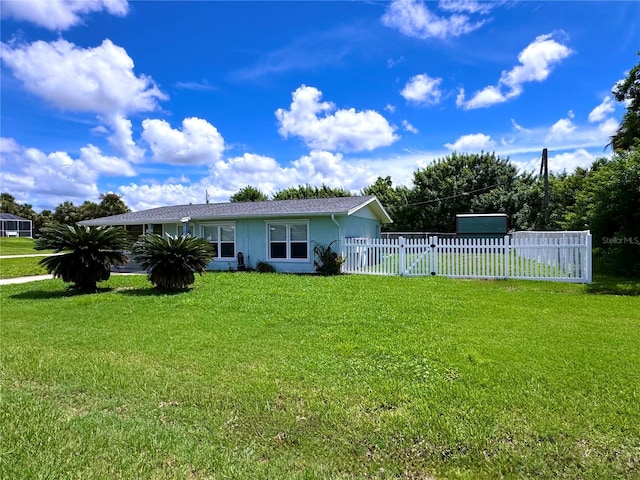 rear view of house with a yard