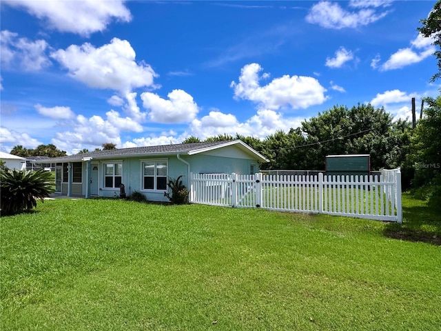 back of house with a yard