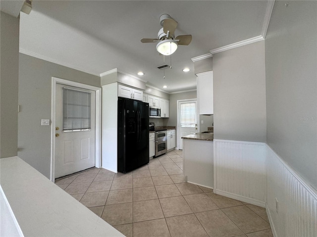 kitchen featuring light tile patterned floors, appliances with stainless steel finishes, ceiling fan, white cabinetry, and crown molding