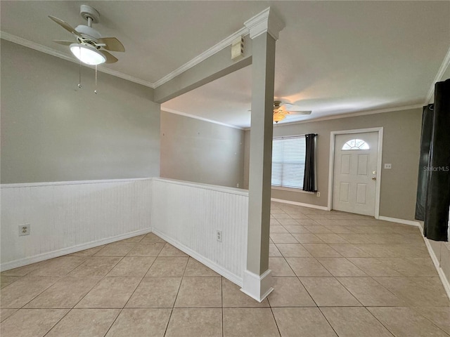 foyer featuring ceiling fan, light tile patterned flooring, and crown molding