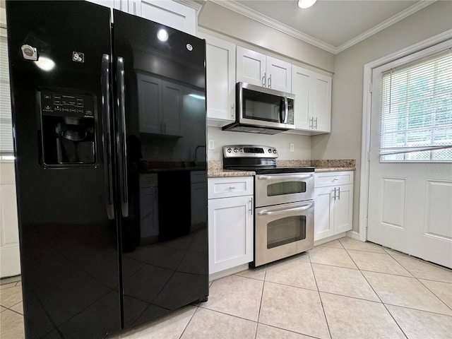 kitchen featuring light tile patterned flooring, appliances with stainless steel finishes, and white cabinets