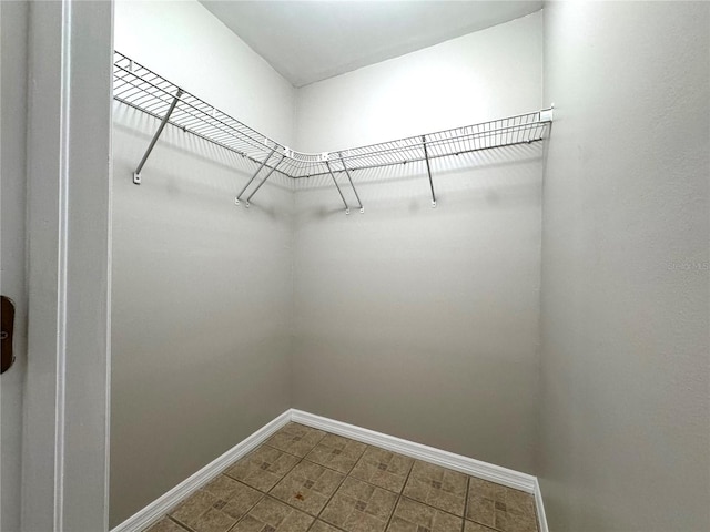 walk in closet with tile patterned flooring