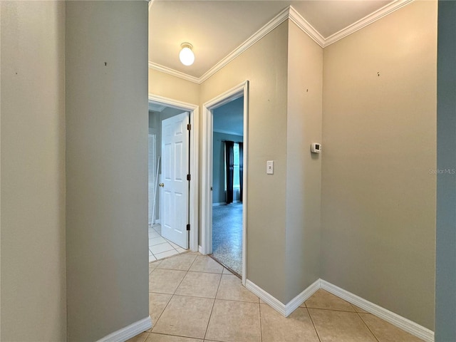 hall with light tile patterned flooring and ornamental molding