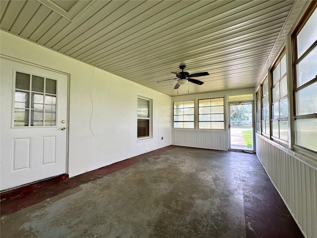 unfurnished sunroom with ceiling fan