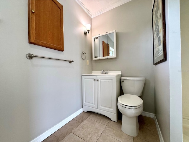 bathroom featuring tile patterned flooring, toilet, ornamental molding, and vanity