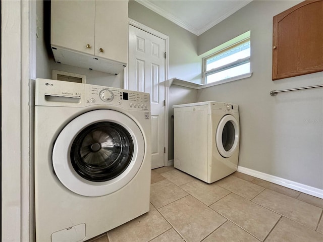 washroom with light tile patterned flooring, independent washer and dryer, and cabinets