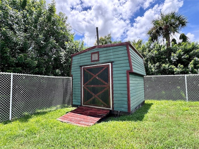 view of outbuilding with a lawn