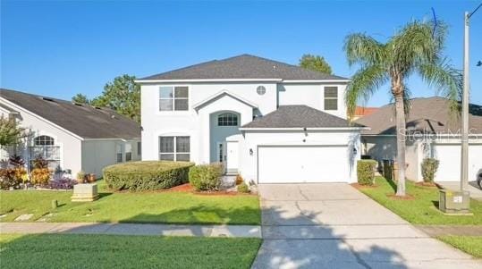 front of property with a garage and a front lawn