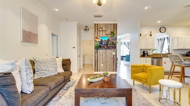 tiled living room with ornamental molding and sink