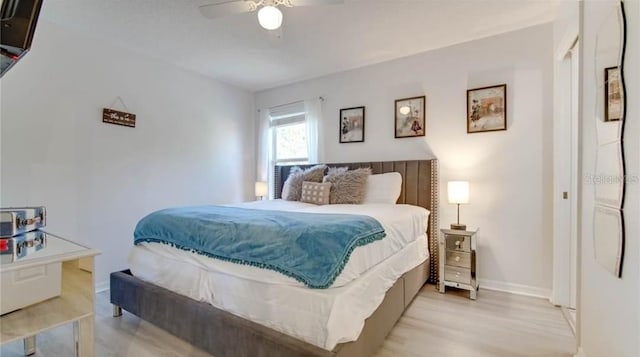 bedroom with ceiling fan and light hardwood / wood-style flooring