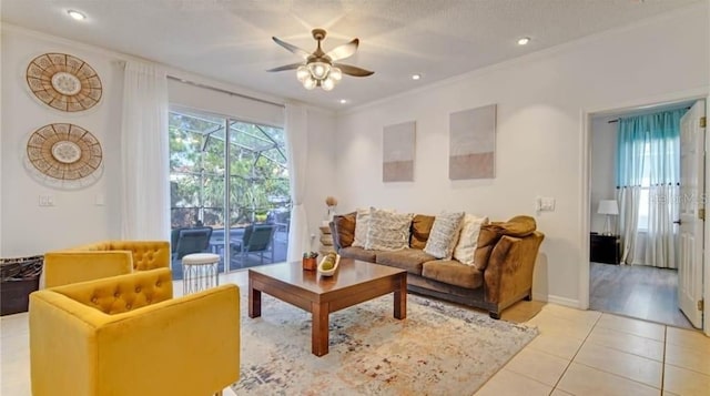 tiled living room with ornamental molding, ceiling fan, and a textured ceiling