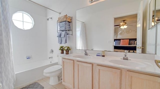 full bathroom featuring ceiling fan, vanity, shower / bath combo with shower curtain, tile patterned floors, and toilet