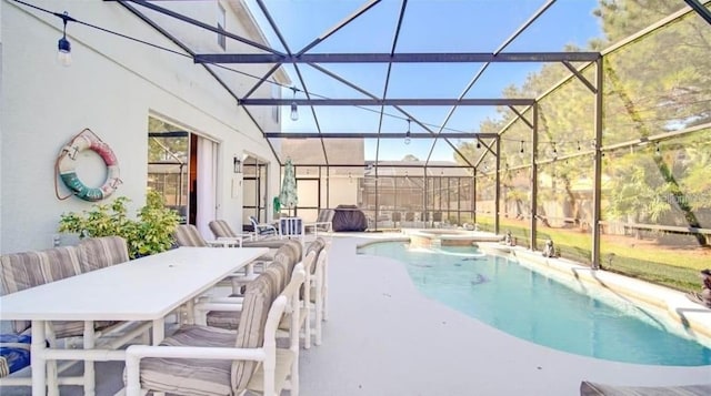 view of swimming pool with an in ground hot tub, glass enclosure, and a patio