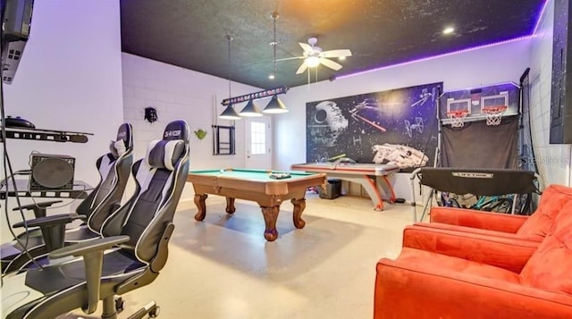 playroom with ceiling fan, billiards, and concrete floors