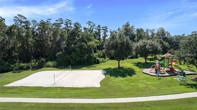 surrounding community featuring a playground, a yard, and volleyball court