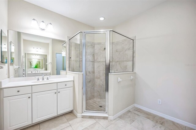 bathroom featuring vanity and a shower with door