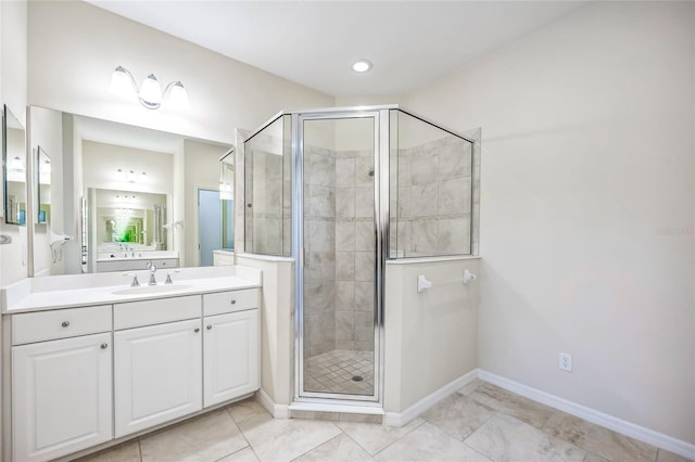 bathroom featuring a shower stall, baseboards, and vanity